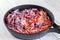 Sliced frozen carrots and beets in a pan. Cooking borsch dressing