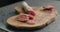 Sliced fuet sausage on olive wood board