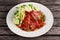 Sliced Gammon Steak with mashed potato on wooden background.