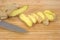 Sliced ginger root with knife on cutting board