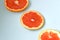 Sliced grapefruits on a blue background