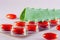 Sliced green leaves of aloe with homeopathic red capsules