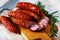 Sliced half-smoked sausages susena on wooden table.