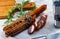 Sliced half-smoked sausages on wooden table