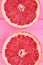 Sliced halves of fresh grapefruit.