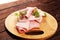 Sliced ham with parsley on table. Fresh prosciutto. Pork ham sliced