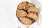 Sliced hazelnuts and banana loaf cake on a ceramic plate.