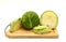 Sliced head of cabbage on a cutting board on a light background.