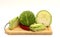 Sliced head of cabbage and red chili pepper on a cutting board on a light background.