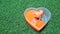 Sliced heart-shaped mango jelly on artificial green grass