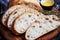 Sliced homemade italian ciabatta bread with olive oil on dark background. Ciabatta, herbs, olive oil, flour. Close up view, copy s