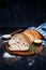 Sliced homemade italian ciabatta bread with olive oil on dark background. Ciabatta, herbs, olive oil, flour. Close up view, copy s