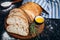 Sliced homemade italian ciabatta bread with olive oil on dark background. Ciabatta, herbs, olive oil, flour. Close up view, copy s