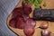 Sliced horse sausage, herbs and spices on cutting board