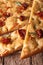 Sliced Italian focaccia with dried tomatoes. macro vertical