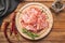 Sliced italian salami sausage with peppercorn on cutting board