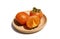 Sliced kaki on wooden plate.Ripe orange tropical persimmon fruit on white.