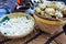 Sliced ketupat in big bamboo bowl in traditional food market in central java