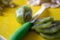 sliced kiwi. preparation of fruit for crepes. yellow cutting board