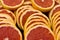 Sliced large circles of ripe juicy grapefruit close-up.