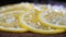 Sliced lemon sprinkled with coarse salt close-up. Background in blur.