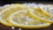 Sliced lemon sprinkled with coarse salt close-up. Snack for alcoholic beverages.
