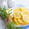 Sliced lemons with rosemary on a plate