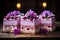 Sliced Lilac cakes with berries, decorated with flowers, dark wooden table