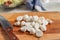 Sliced little mozzarella balls on a wooden board. Salad ingredient Italian cuisine