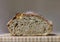 Sliced loaf of artisanal whole wheat and dark rye rustic sourdough bread on a cutting board, baked at home, photo series