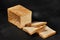 Sliced loaf of fresh, palatable baked white bread against black background with copy space. Close-up