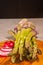 Sliced, local, ripe radish and bundle of asparagus on a rare wood plate