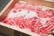 Sliced marbled Kobe wagyu beef served on wood box for shabu shabu