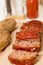 Sliced Meatloaf and Baked Potatoes on Wood Board