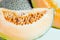 Sliced melon with seed on wooden board Other names are cantelop