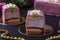Sliced mousse desserts with almond biscuit, strawberry coolie and strawberry mousse covered gourmet pink chocolate glaze