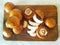 Sliced mushrooms on a wooden board. Preparation of champignons. Ð¡utting board.