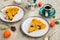 Sliced open pie with pumpkin and prunes on a ceramic plate on a gray concrete background. Pumpkin recipes. Thanksgiving desserts