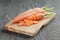 Sliced organic carrot on olive wood cutting board