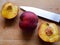 Sliced peaches on a wooden plate