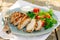 Sliced peanut crusted chicken breast with fresh salad