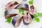 Sliced pickled atlantic herring on a white dish closeup