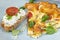 Sliced pieces of omelet with bread on a plate. Omelet in the oven with green beans, tomatoes, herbs and cheese.