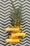 Sliced pineapple on graphic summer background. Tropical fruit sliced pineapple rings. Creative flat lay composition on