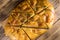 Sliced pita bread on cutting board on wooden table