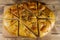 Sliced pita bread on cutting board on wooden table