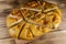 Sliced pita bread on cutting board on wooden table