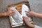 Sliced pizza on the table. Hands of three human are takes for a last piece on table.