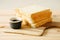 Sliced plain bread with jam on wooden tray