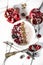 Sliced pomegranate and homemade fresh yoghurt with forest fruits and cereal. White marble pattern background.